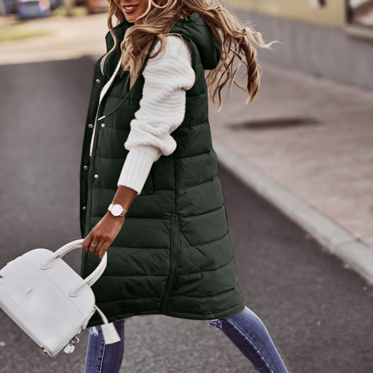 Women's long quilted down vest with hood, insulated cold-weather layering piece in sleek winter style
