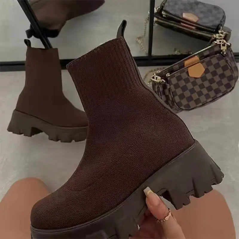 Women's black water-repellent high top sock boots with thick platform sole and mid-calf fit