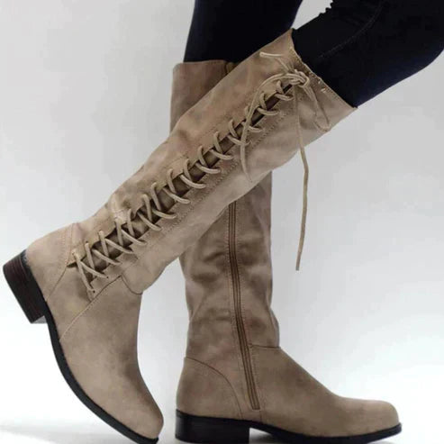Women's black lace-up knee-high boots with side zip, flat sole, and fashion-forward fall silhouette