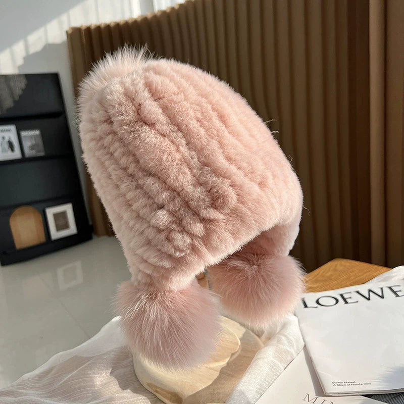 Women's ribbed knit beanie hat in neutral tone with fur trim pompoms, close-fit cozy winter style