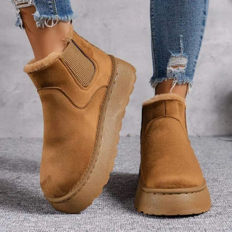 Women's winter snow boots in white plush-lined synthetic leather with cozy cold weather comfort
