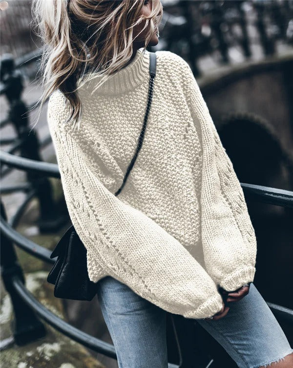 Women's oversized chunky knit turtleneck pullover sweater with eyelet details for a cozy modern look