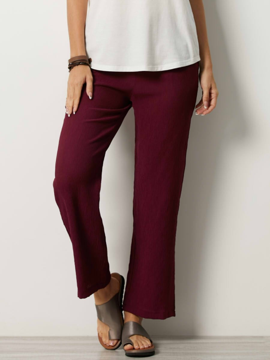 Women's relaxed fit lightweight pants with elastic waist, side pockets, and crinkled texture