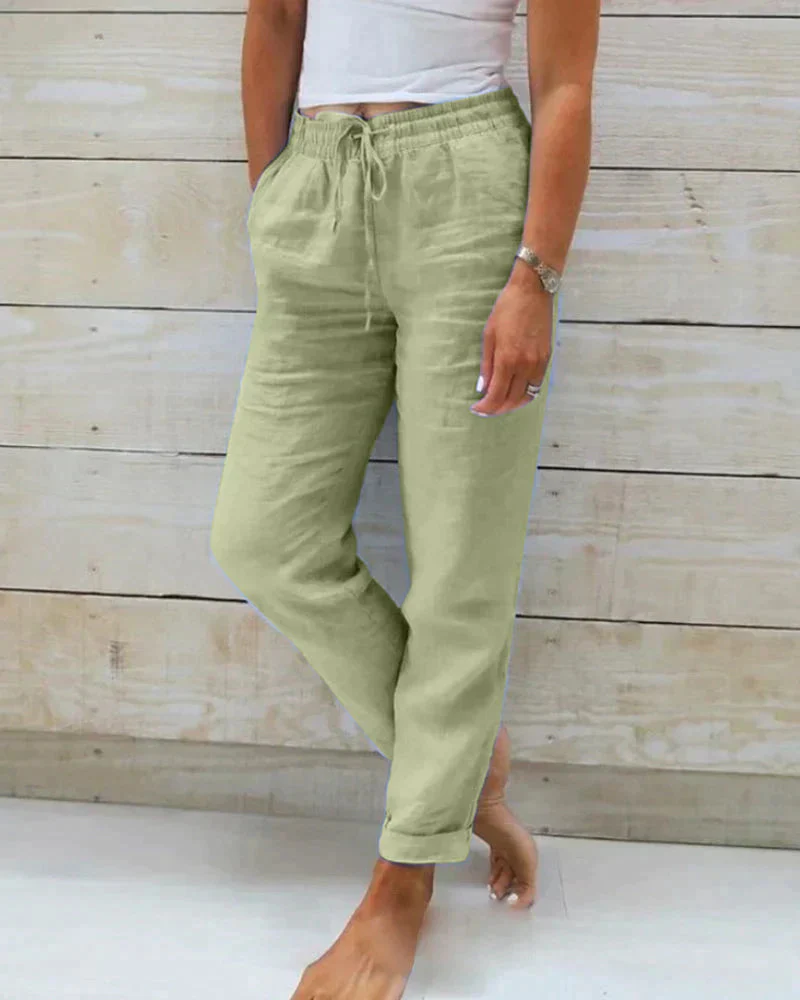 Beige linen straight-cut summer pants with elastic drawstring waistband and rolled legs