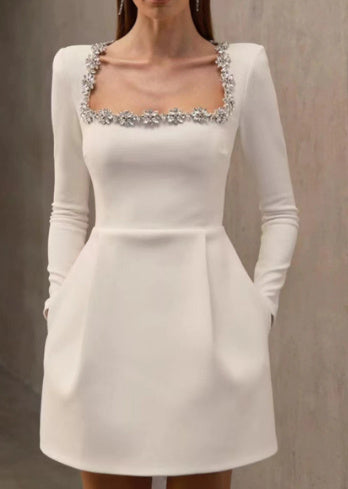 White floral embellished mini dress with square neckline, long sleeves, and fitted silhouette for women
