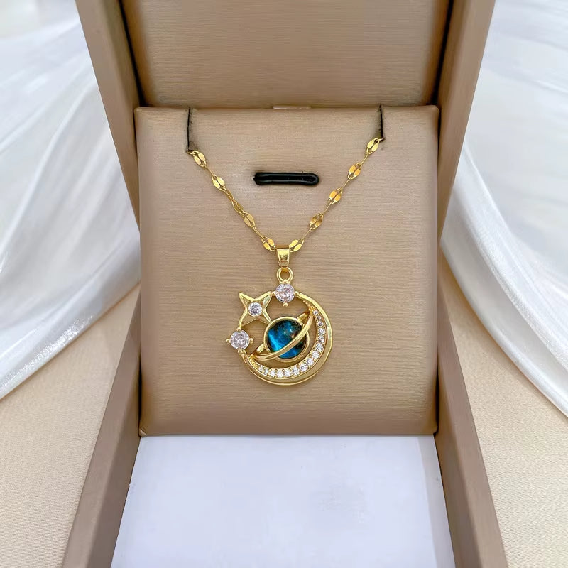 Celeste gold sunburst pendant necklace with blue centerpiece, celestial clavicle-length chain
