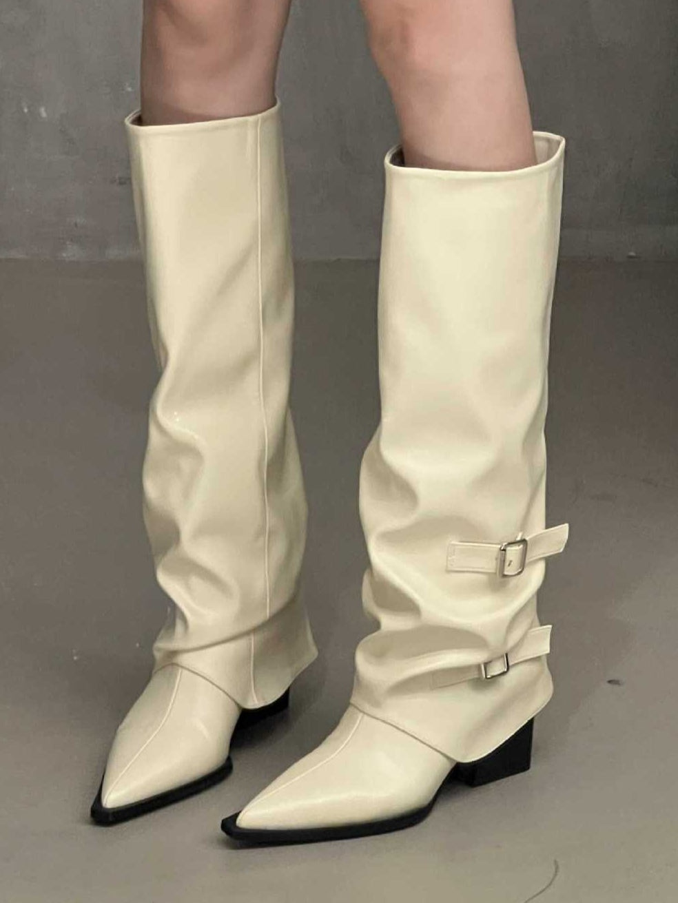 Women's black high-top block heel boots with pointed toe and edgy belt buckle detail