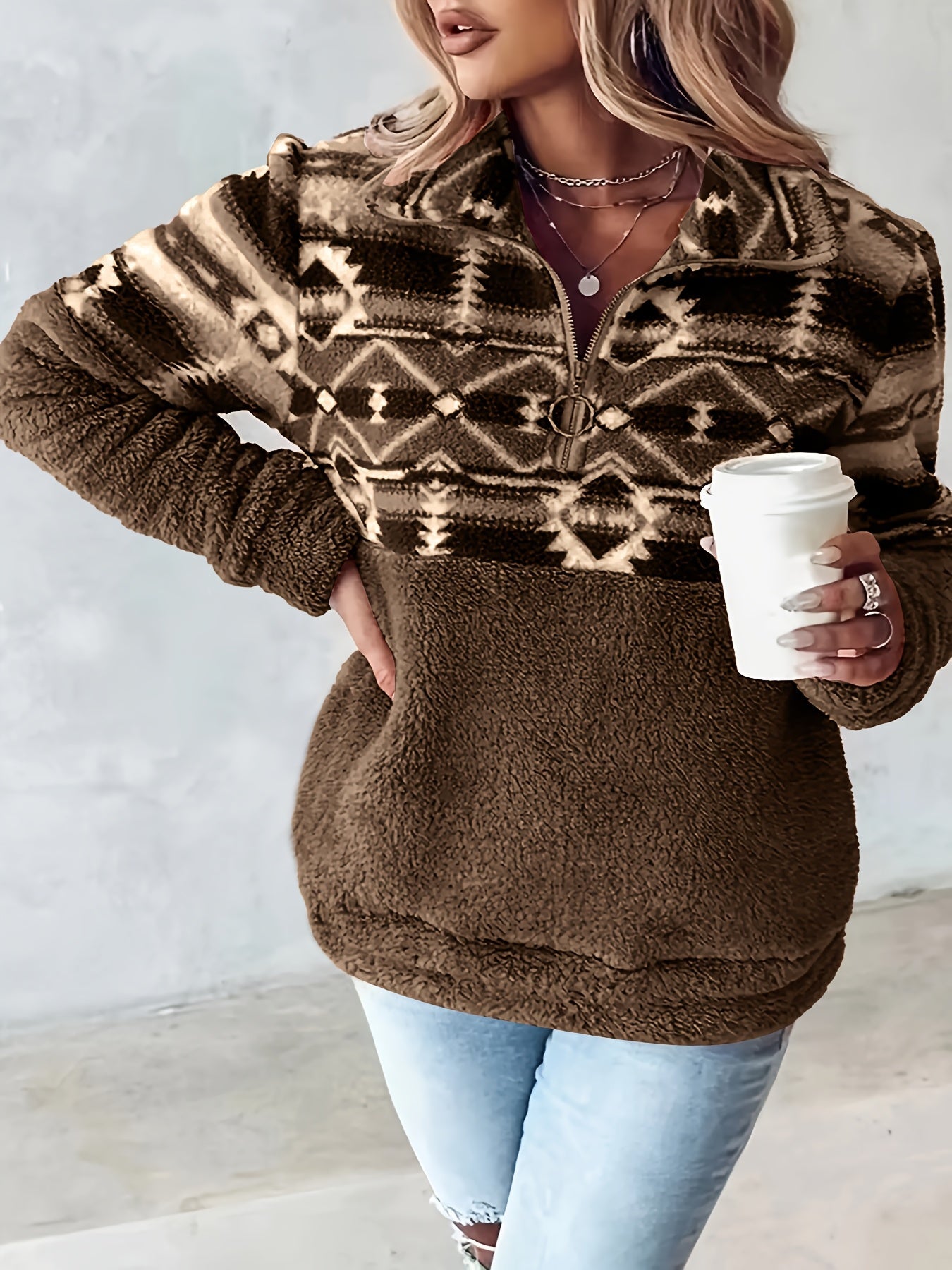Casual half zip fleece sweater with Aztec pattern accent and kangaroo pocket in neutral tones