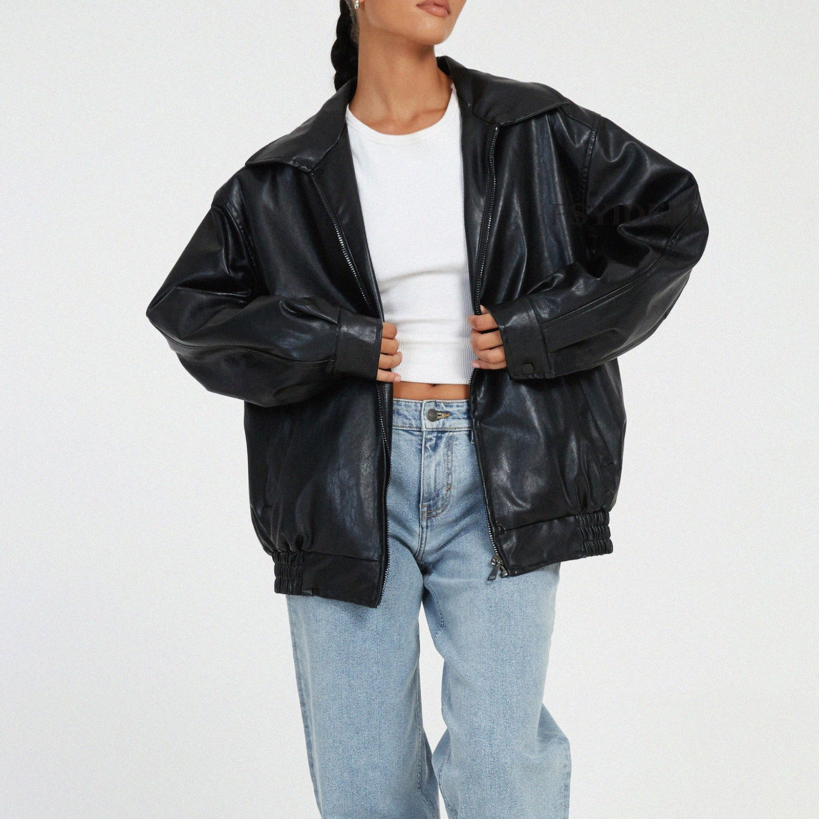 Women's black vegan leather locomotive coat with streamlined silhouette and statement outerwear styling