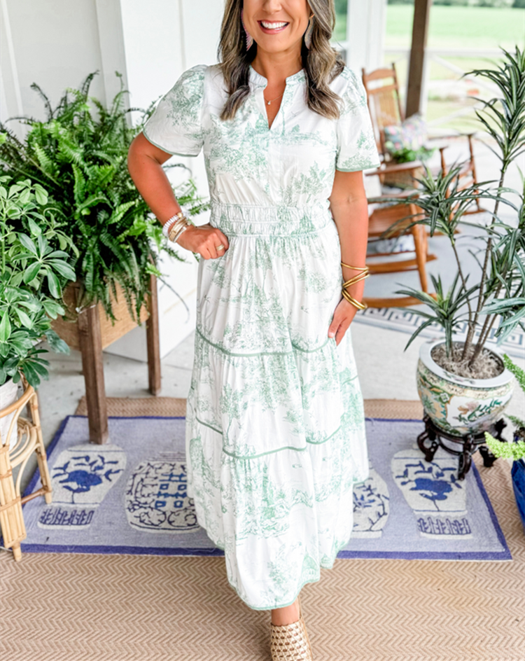 Women's printed button-front maxi dress with artistic illustration print and defined waist silhouette