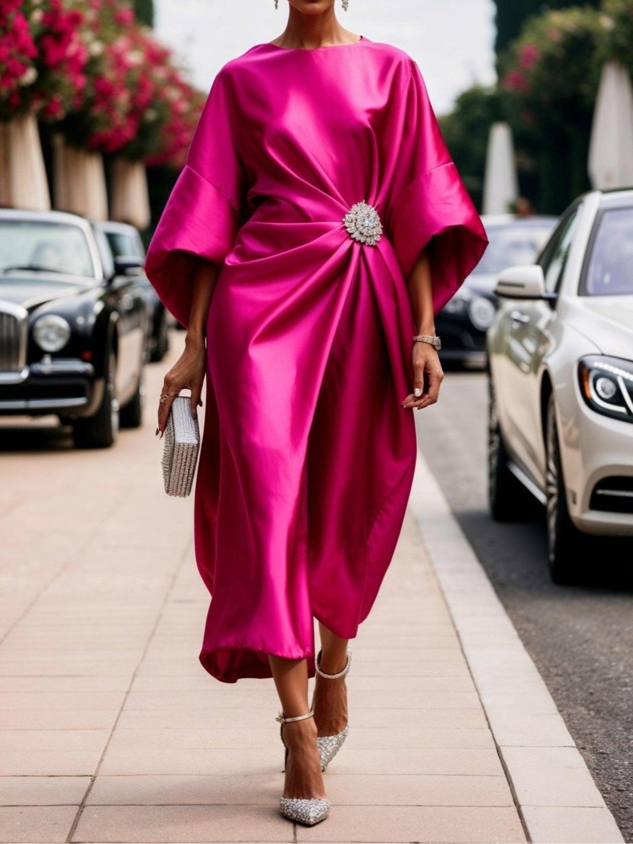 Black draped batwing sleeve evening gown with sculptural silhouette and elegant brooch detail