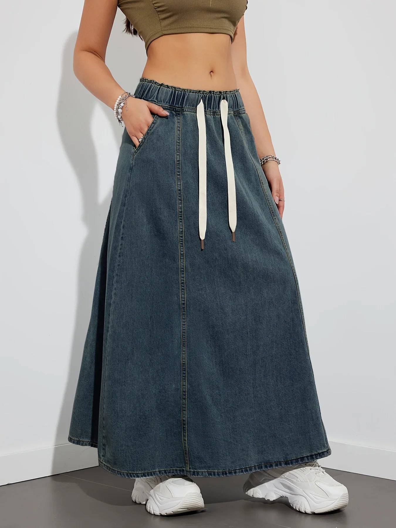 Women's high-rise maxi A-line denim skirt in washed blue Y2K-inspired silhouette with drawstring waist