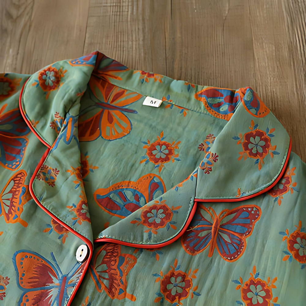 Women's butterfly print pajama set with long-sleeve button-front top and elastic waistband cozy fit