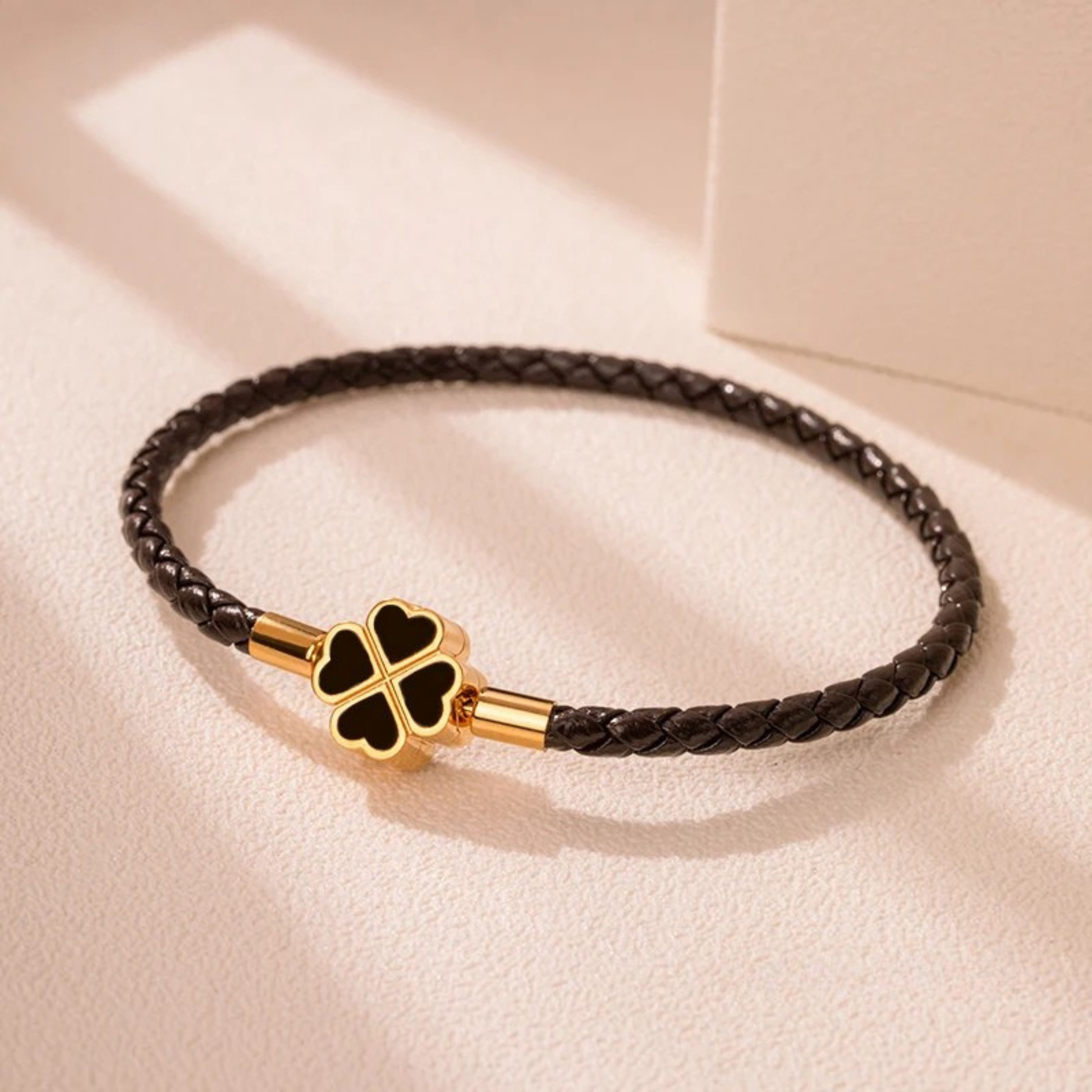 Hand-braided cowhide leather bracelet with 18K gold four-leaf clover charm, hypoallergenic tarnish-resistant