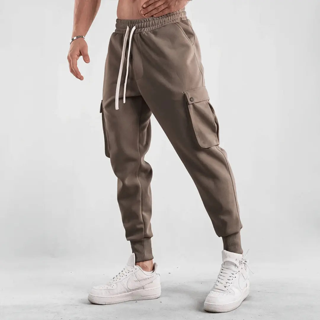 Black cargo joggers with adaptive flex fabric, tapered street-fit cut and multi-pocket utility design