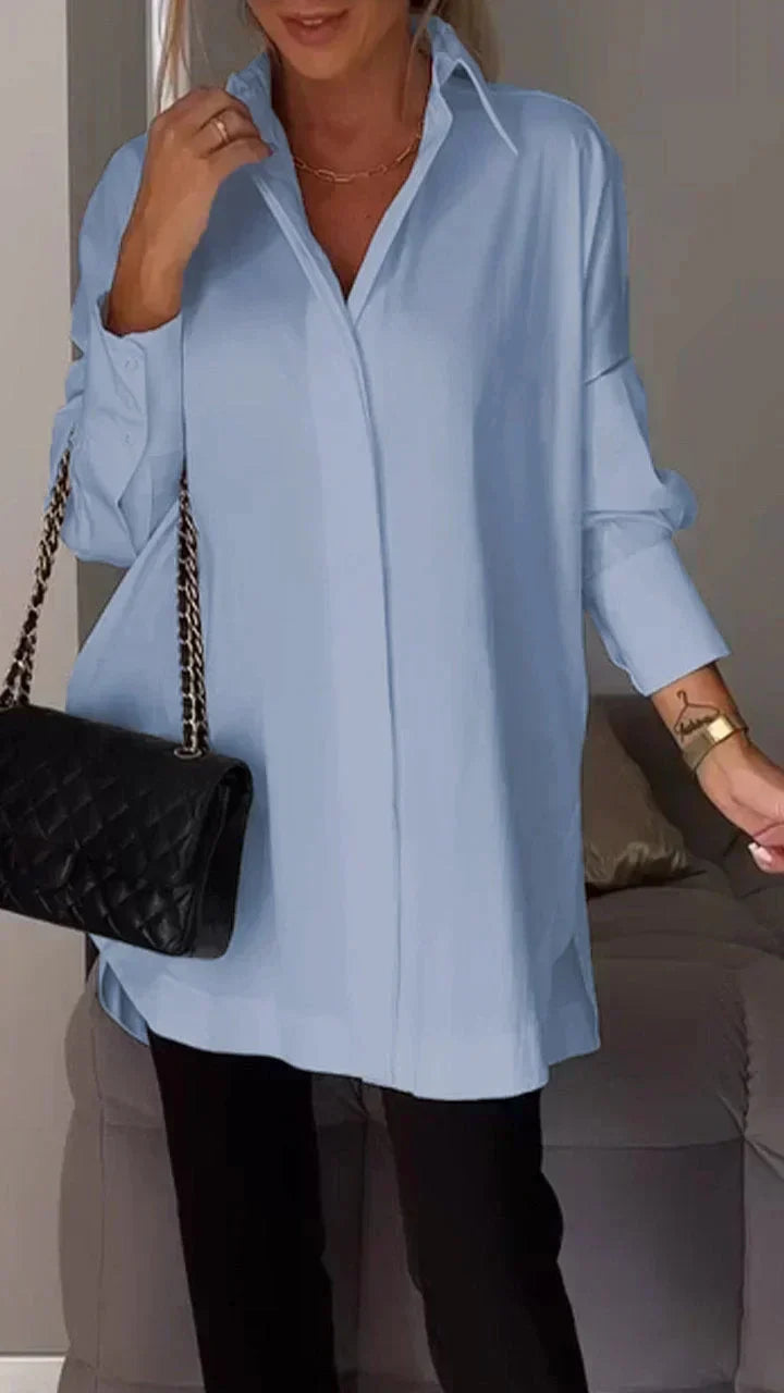 Women's oversized white blouse with rolled-up sleeves, relaxed silhouette, easy-care chic style