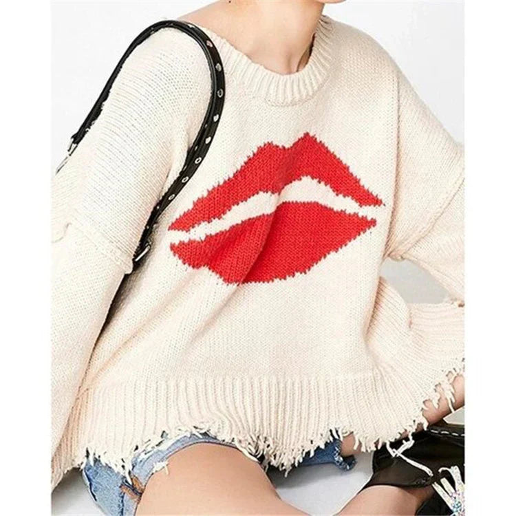 Women's chunky knit cropped sweater with lip motif and fringed hem, bold Nordic-inspired cozy style