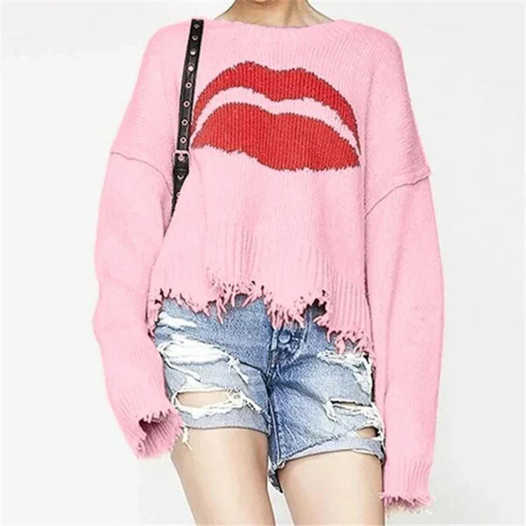 Women's chunky knit cropped sweater with lip motif and fringed hem, bold Nordic-inspired cozy style