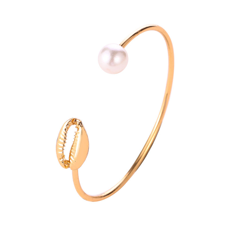 Delicate pearl and shell open bangle bracelet with coastal maritime design for women