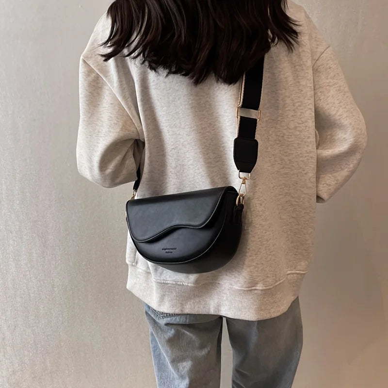 Mini saddle crossbody bag smooth matte vegan leather sculptural wave-edge flap minimalist city style
