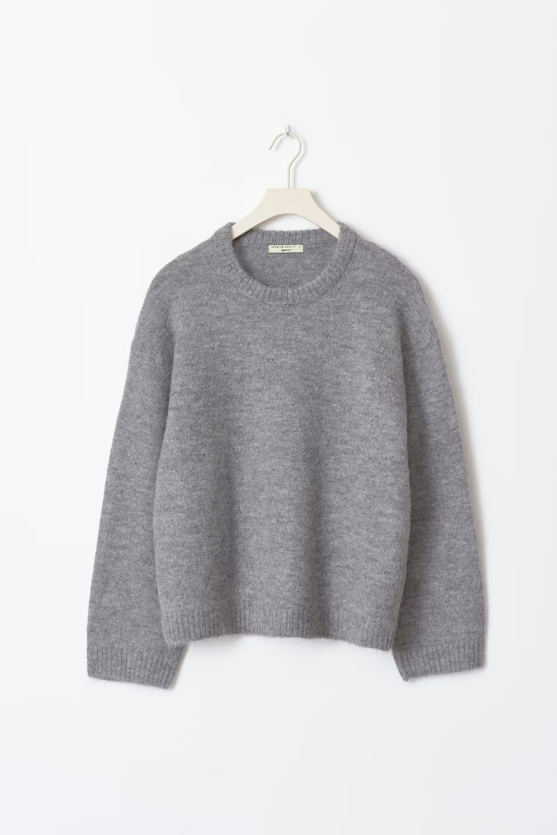 Beige oversized women's sweater with loose fit, round neckline, and relaxed everyday silhouette