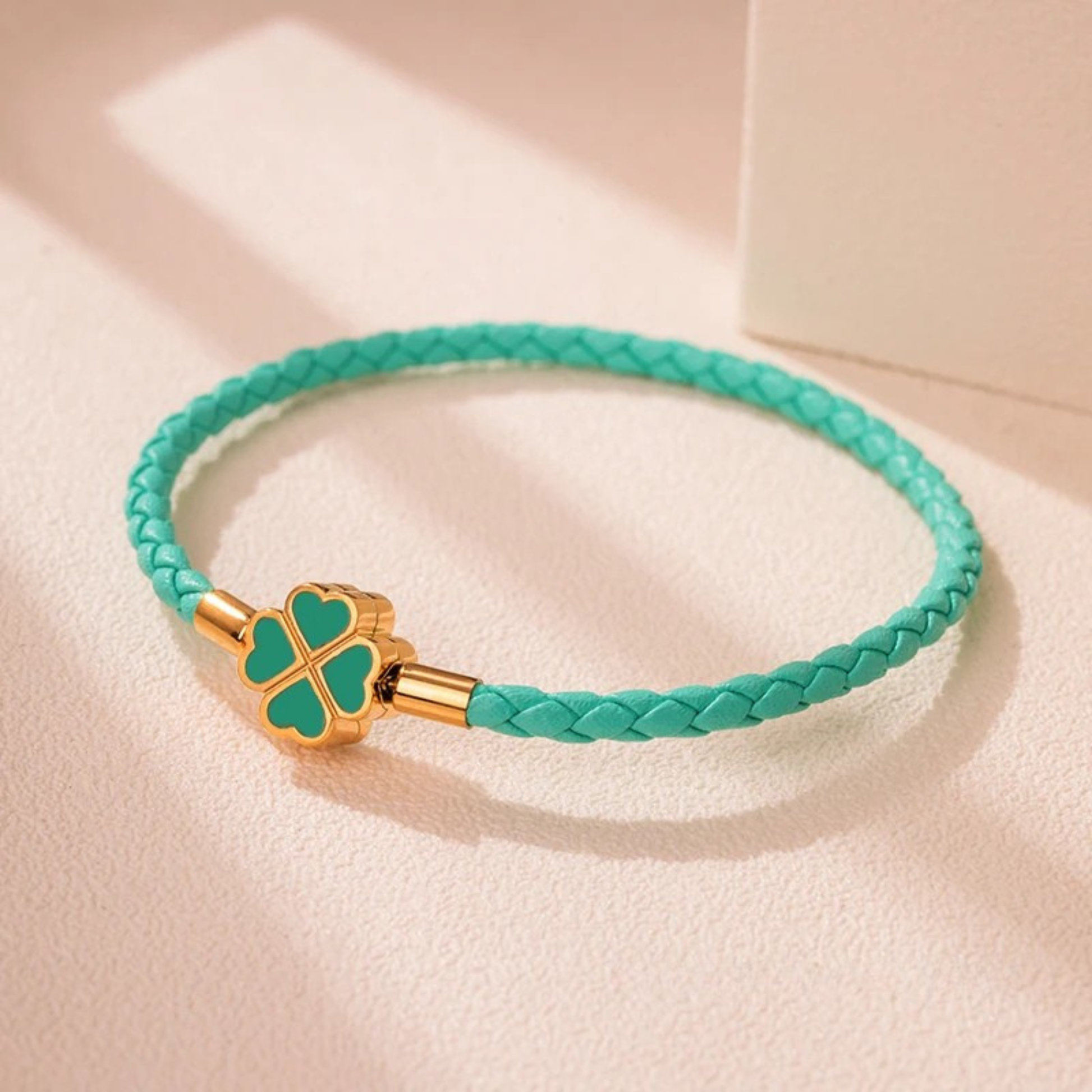 Hand-braided cowhide leather bracelet with 18K gold four-leaf clover charm, hypoallergenic tarnish-resistant