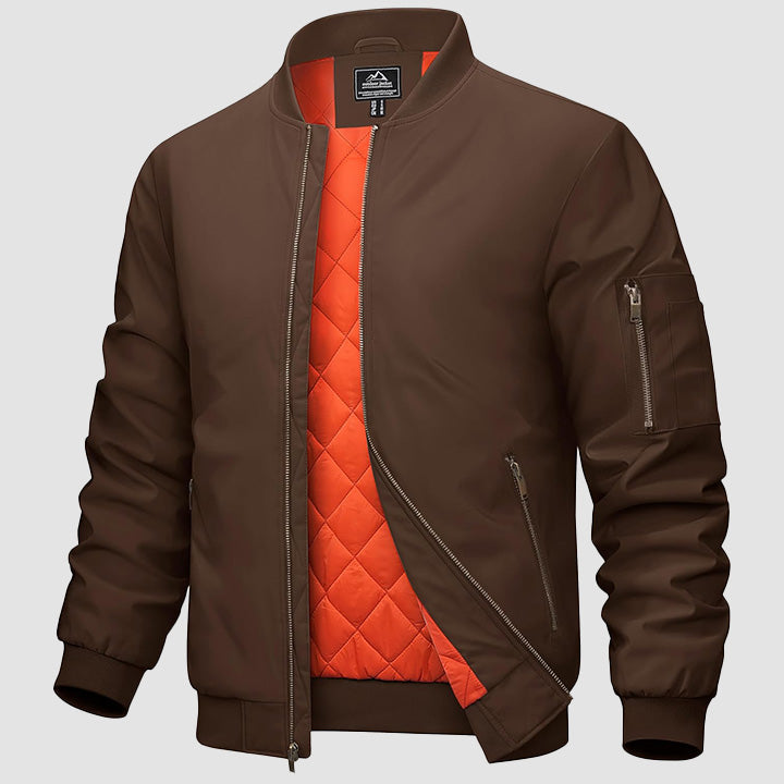 Men's navy bomber jacket zip-up windbreaker with quilted orange interior lining and multi-pocket design