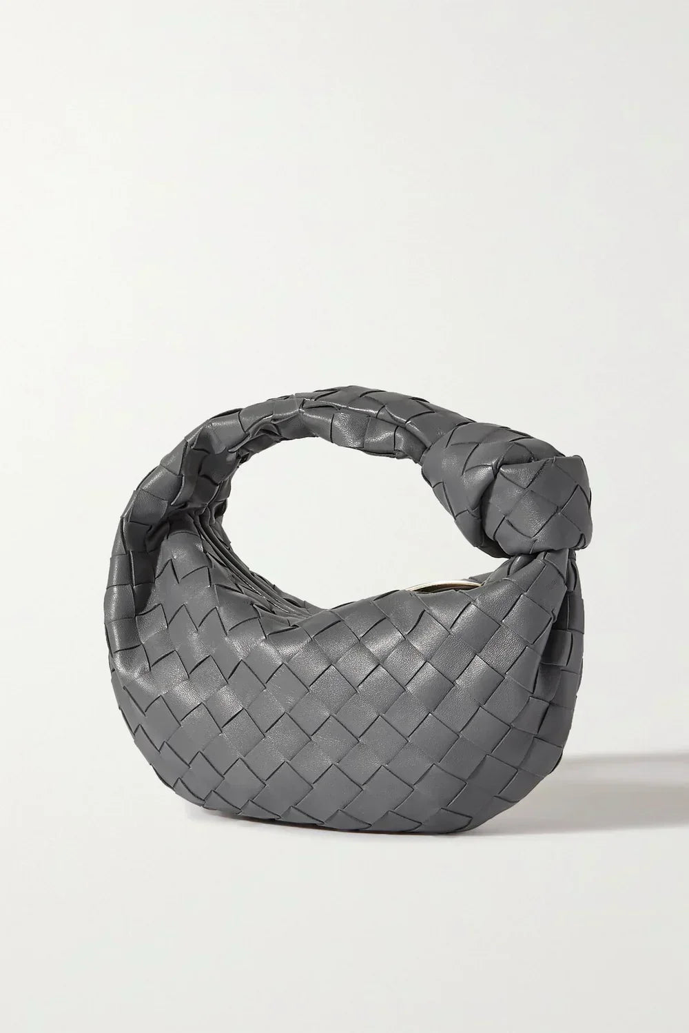 Women's woven shoulder bag with knotted handle, spacious interior, chic everyday versatile design