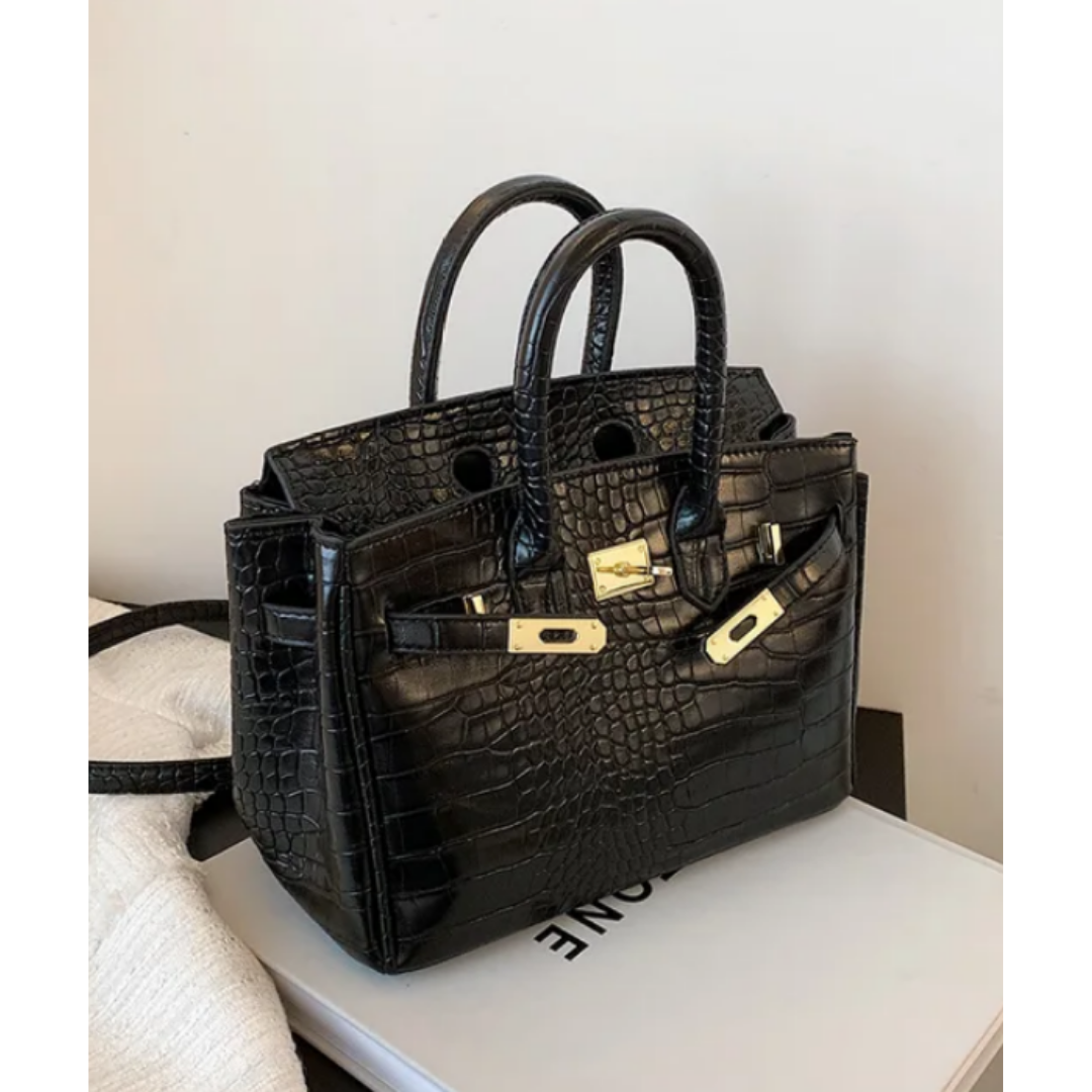 Large women's designer crossbody handbag in neutral tone, elegant silhouette with adjustable strap