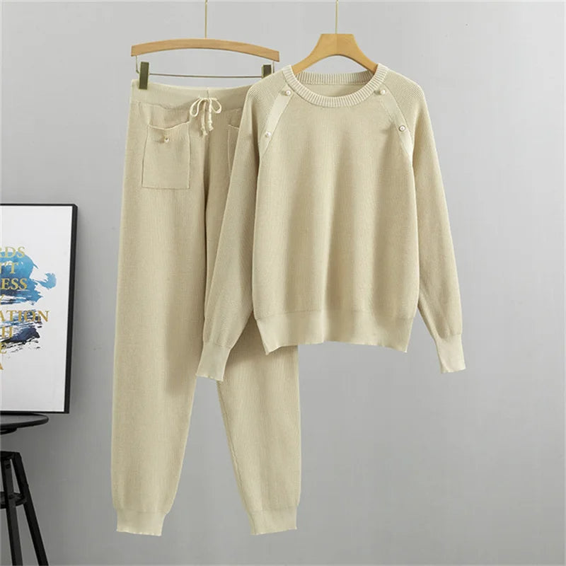 Cream knit two-piece lounge set with pearl-accented sweater and relaxed-fit jogger pants