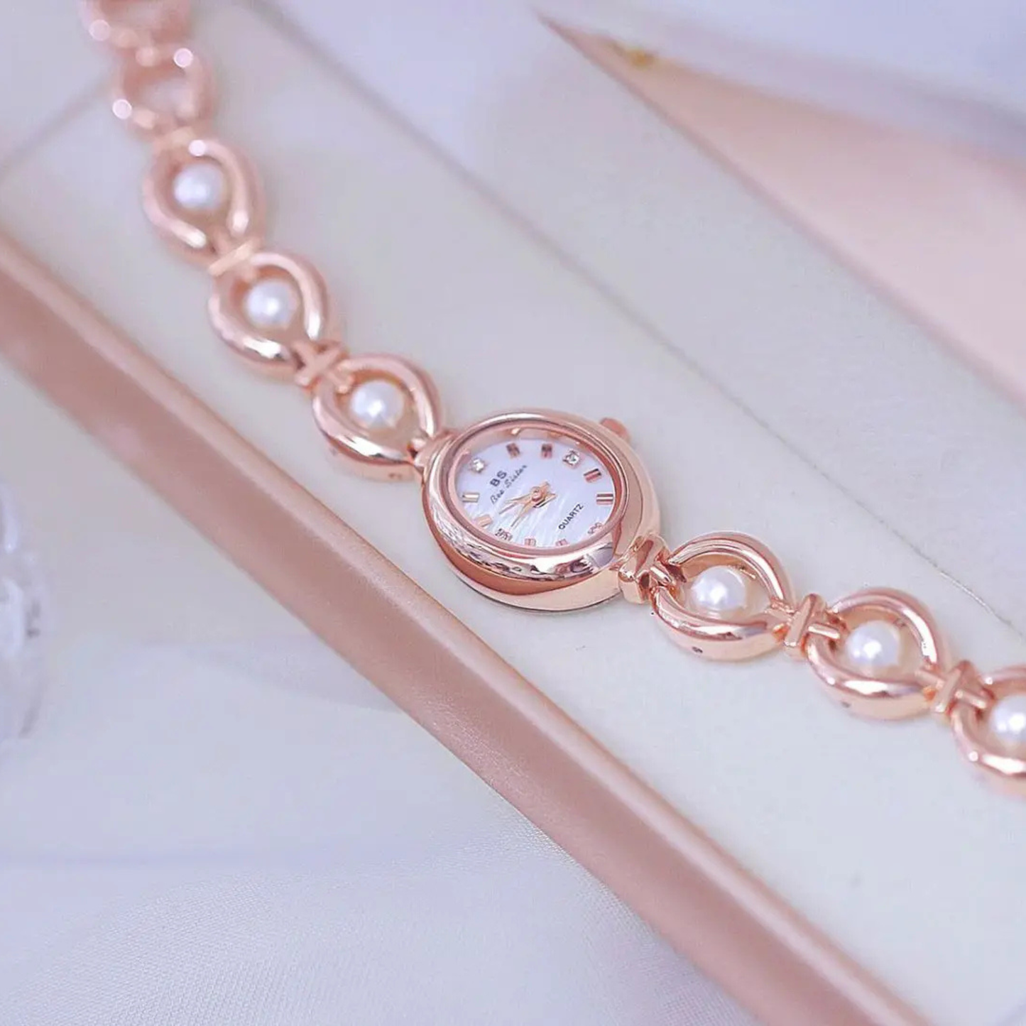 Lyra women's pearl-link quartz watch with natural fritillaria dial and crystal hour markers