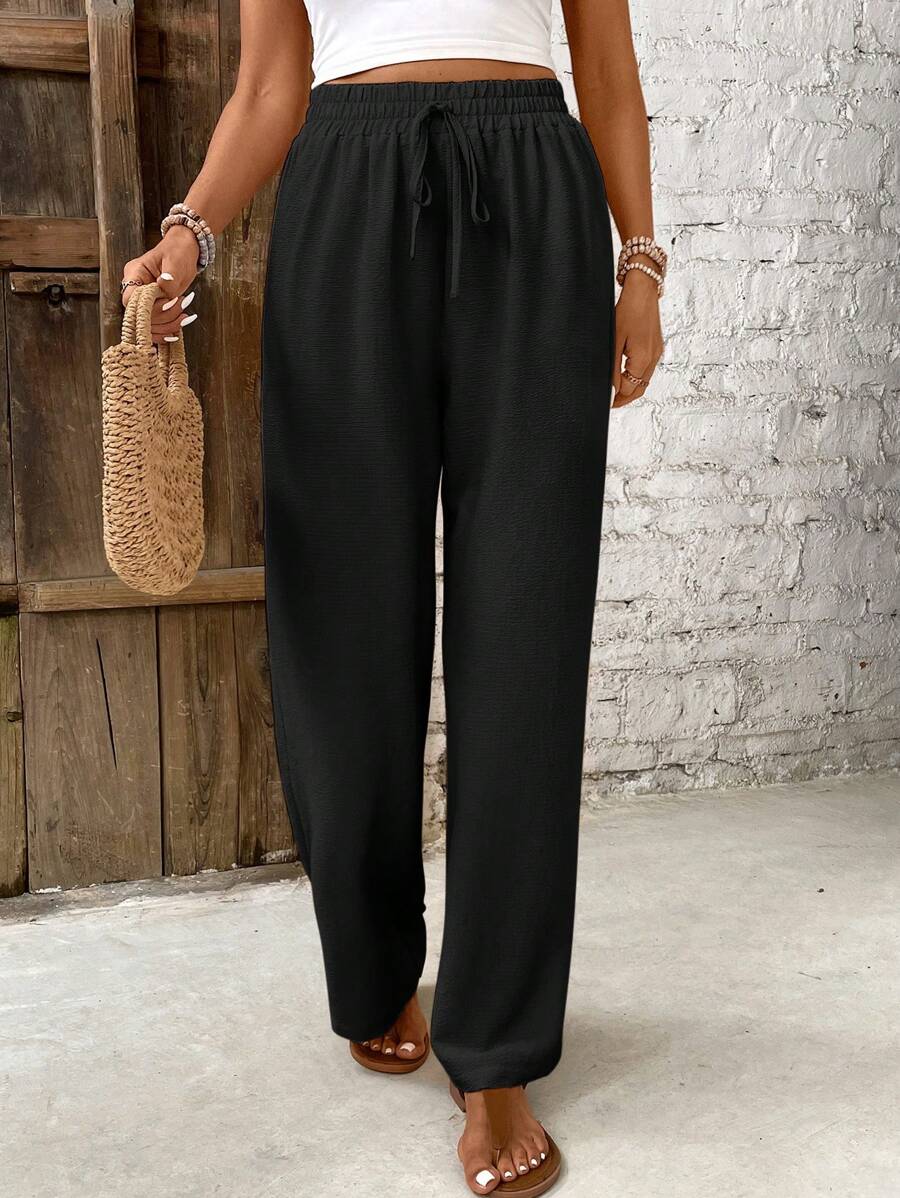 Women's white high-waist lounge pants with airy wide-leg silhouette and minimalist holiday style