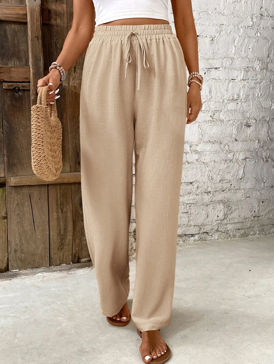 Women's white high-waist lounge pants with airy wide-leg silhouette and effortless minimalist drape