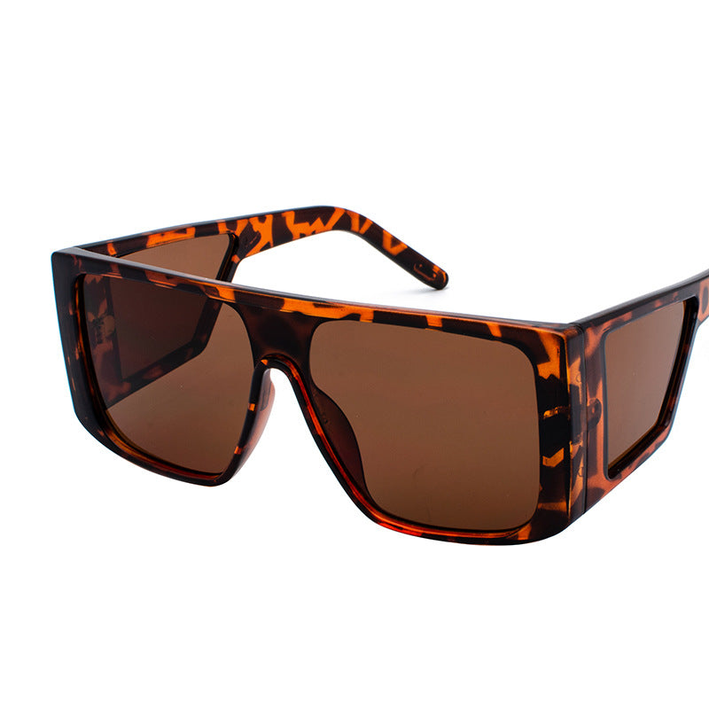 Oversized angular retro sunglasses with colored UV400 lenses, bold futuristic festival style