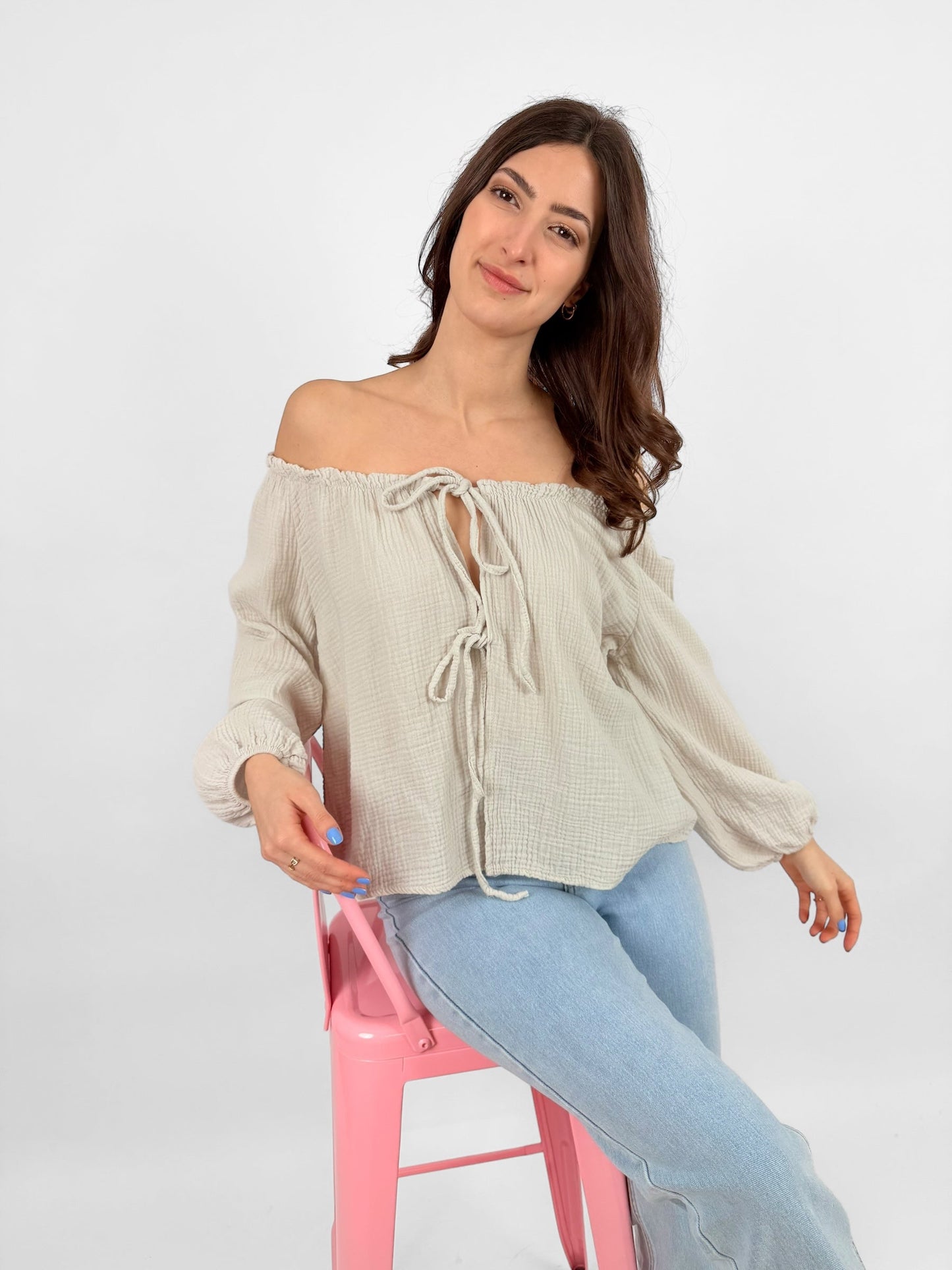 Women's white muslin blouse lightweight breathable fabric with delicate bow accents for everyday elegance