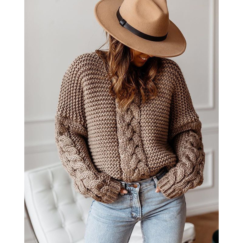 Oversized chunky cable knit sweater in cozy neutral tones with thick textured handcrafted detailing