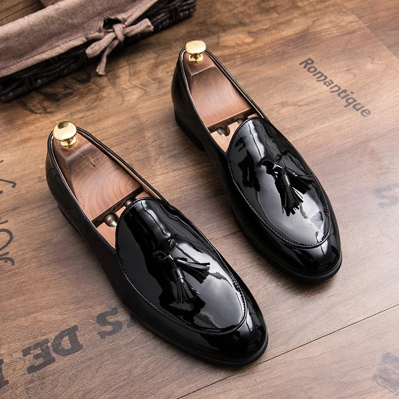 Midnight patent leather loafer with iridescent blue sheen and hand-tied tassels for professionals
