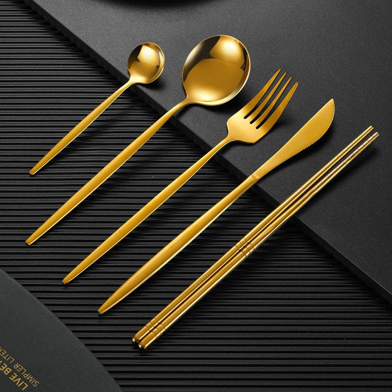 Gold finish stainless steel cutlery set with matte black handles, luxurious modern dining design