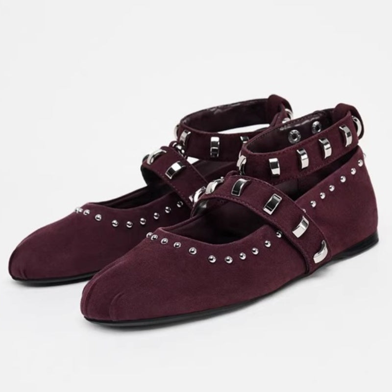 Black punk flat shoes with edgy strap detail, stud accents, and flexible sole for bold streetwear style