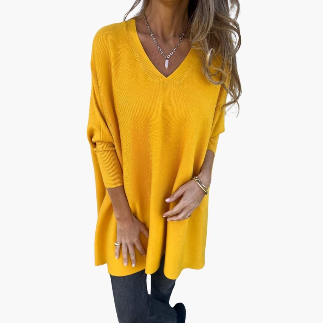 Women's loose-fit V-neck knit sweater in neutral tone, relaxed silhouette with elegant neckline