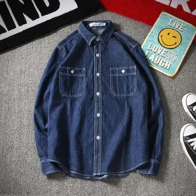 Washed denim shirt jacket with curved hem, dual chest pockets, structured fit for professionals