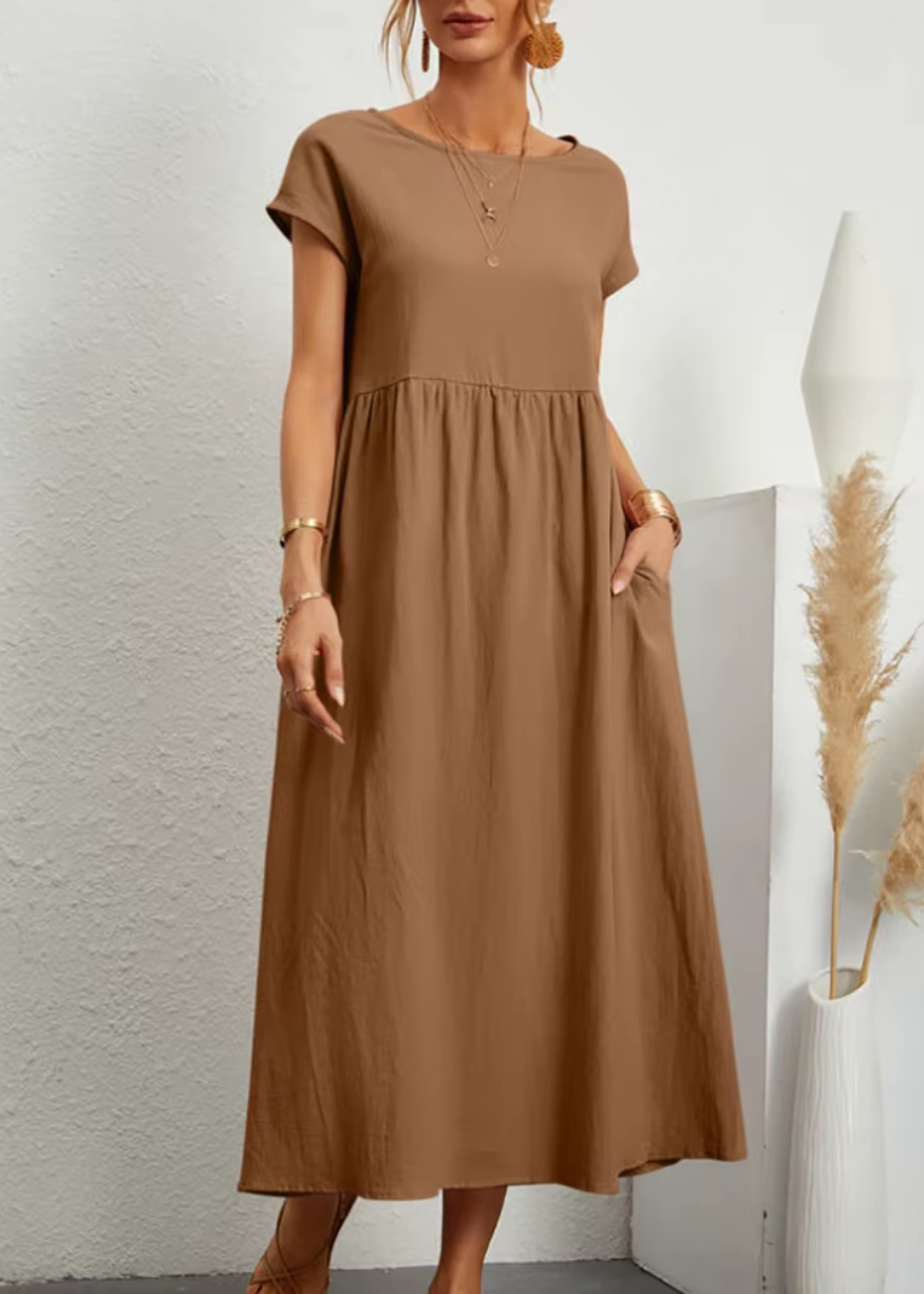 Women's relaxed midi dress with short sleeves, gathered waist, flowy silhouette, and side pockets