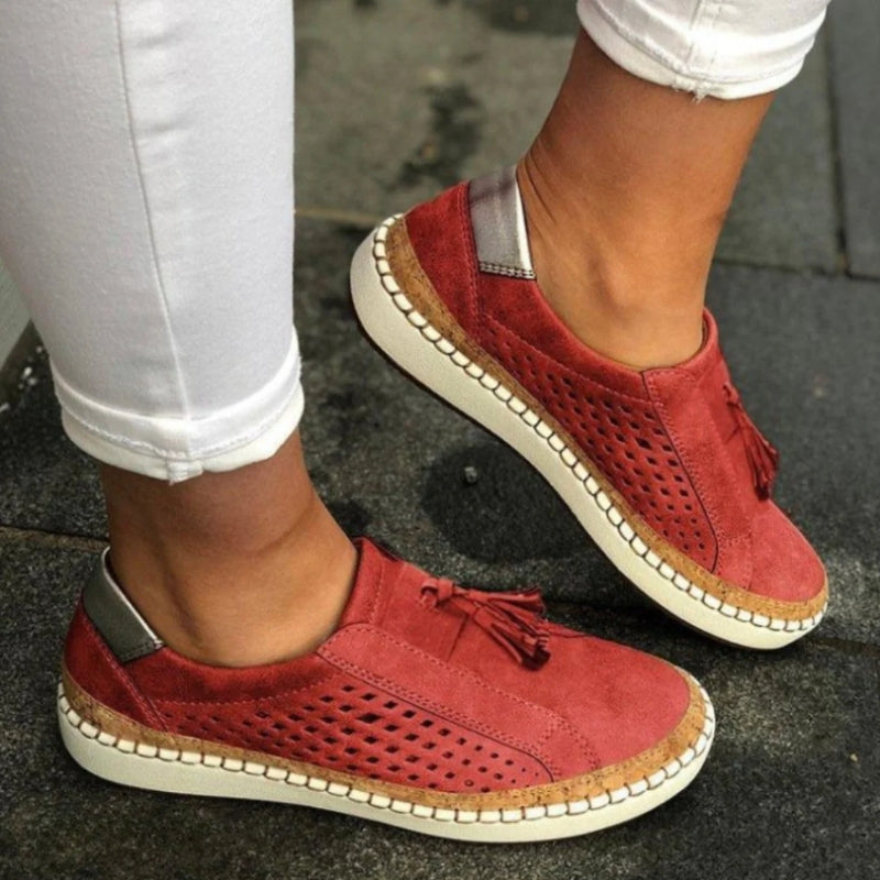Women's white perforated slip-on sneakers with flexible sole and breathable mesh-like upper