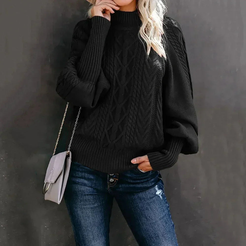 Women's oversized cream cable knit sweater with high neck relaxed fit and rich textured detailing
