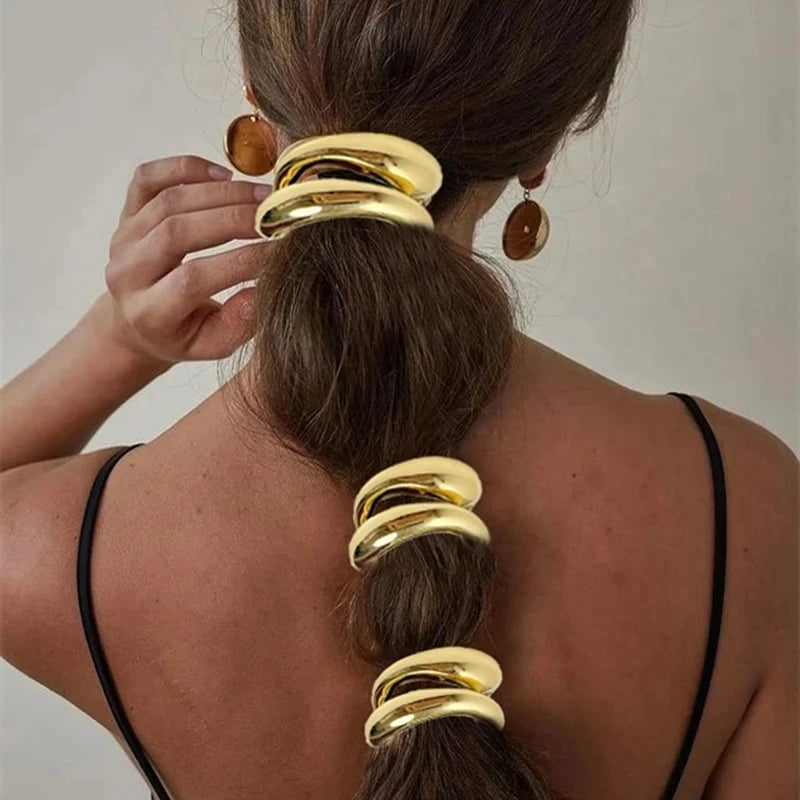 Set of 3 stackable high-shine gold sculptural ponytail cuffs for braids and updos