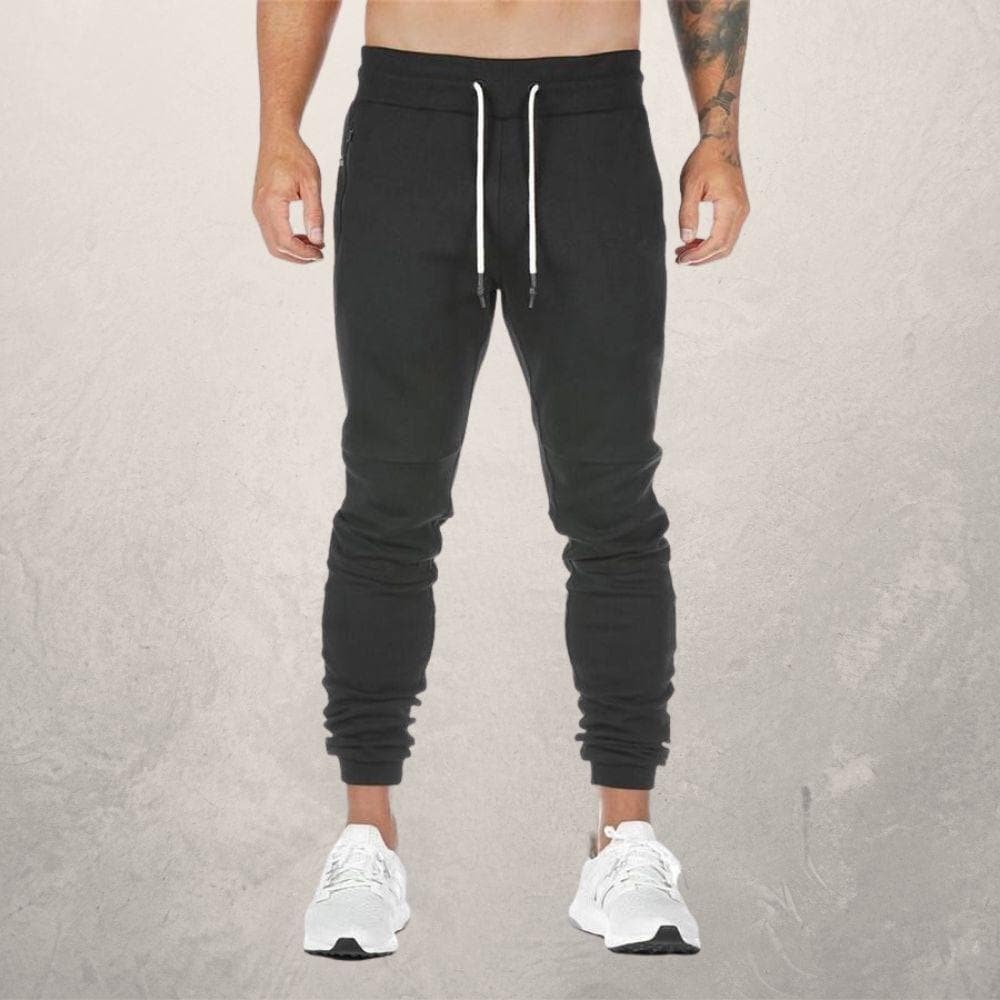 Men's slim fit joggers with elastic drawstring waist, zipper pockets, and ribbed cuffs for a modern look