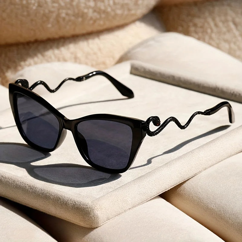 Oversized cat-eye sunglasses with sculpted snake arms, electric acetate frames, and UV400 protection