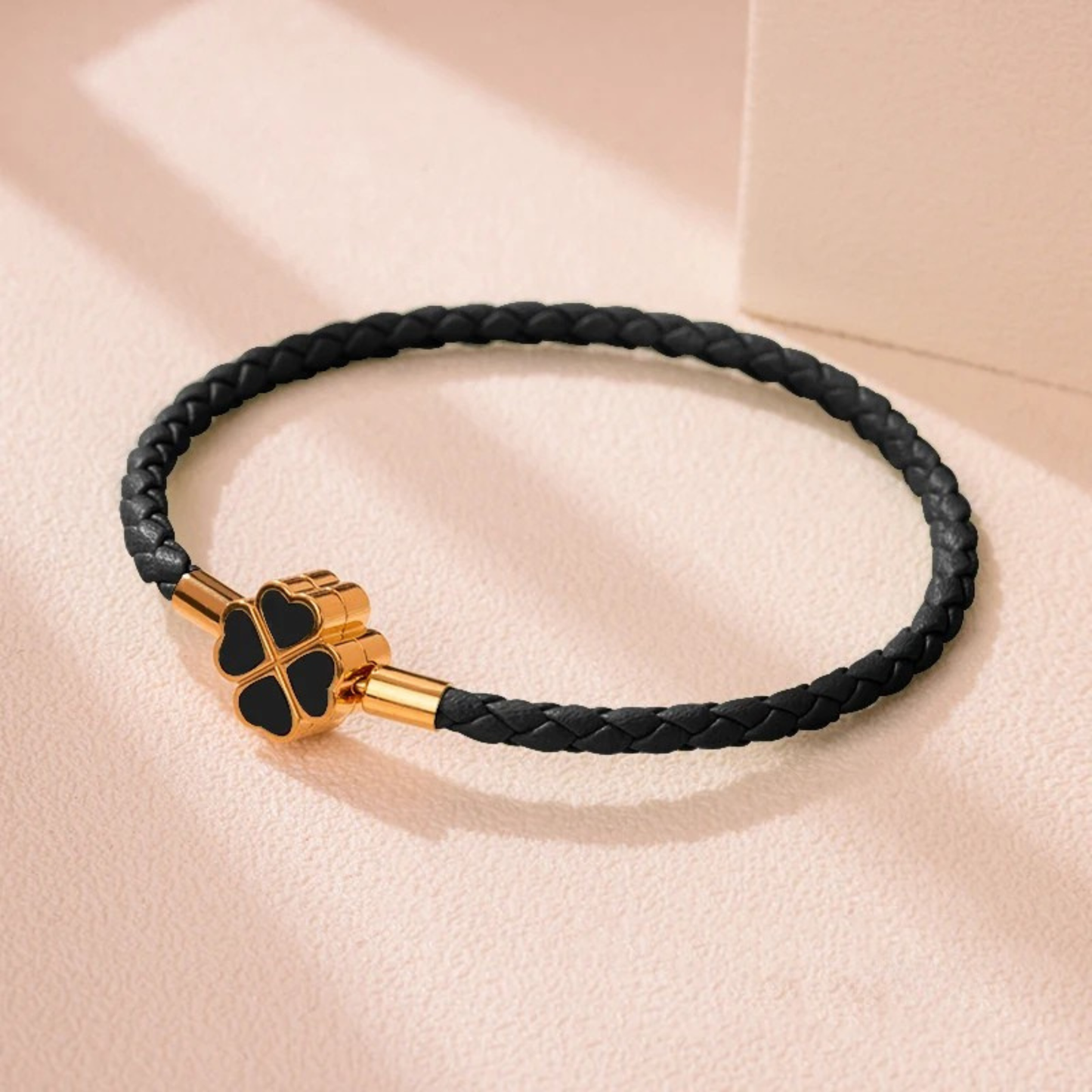 Hand-braided cowhide leather bracelet with 18K gold four-leaf clover charm, hypoallergenic tarnish-resistant