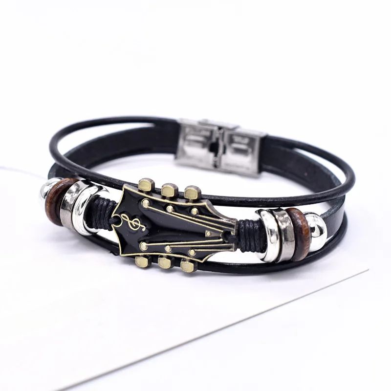 Brown leather guitar bracelet vintage-inspired music accessory with engraved guitar charm detail