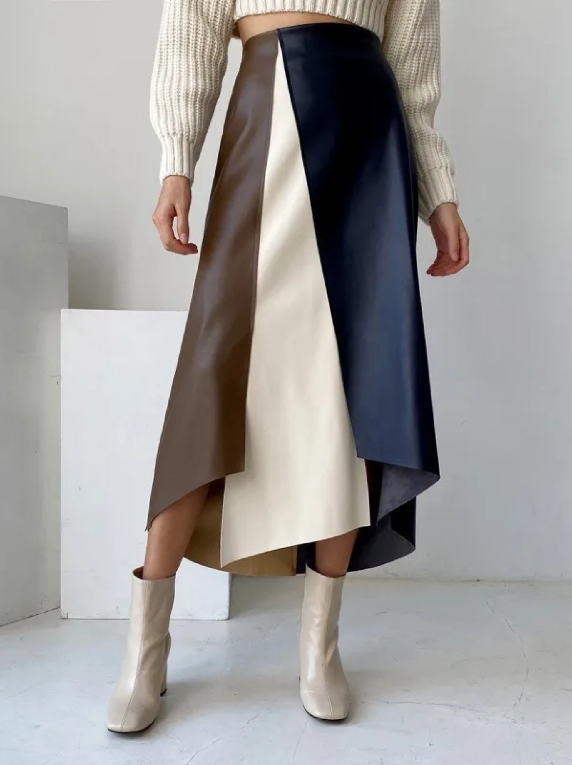 Tri-color block vegan leather mini skirt with contoured high-rise waist and asymmetric hem